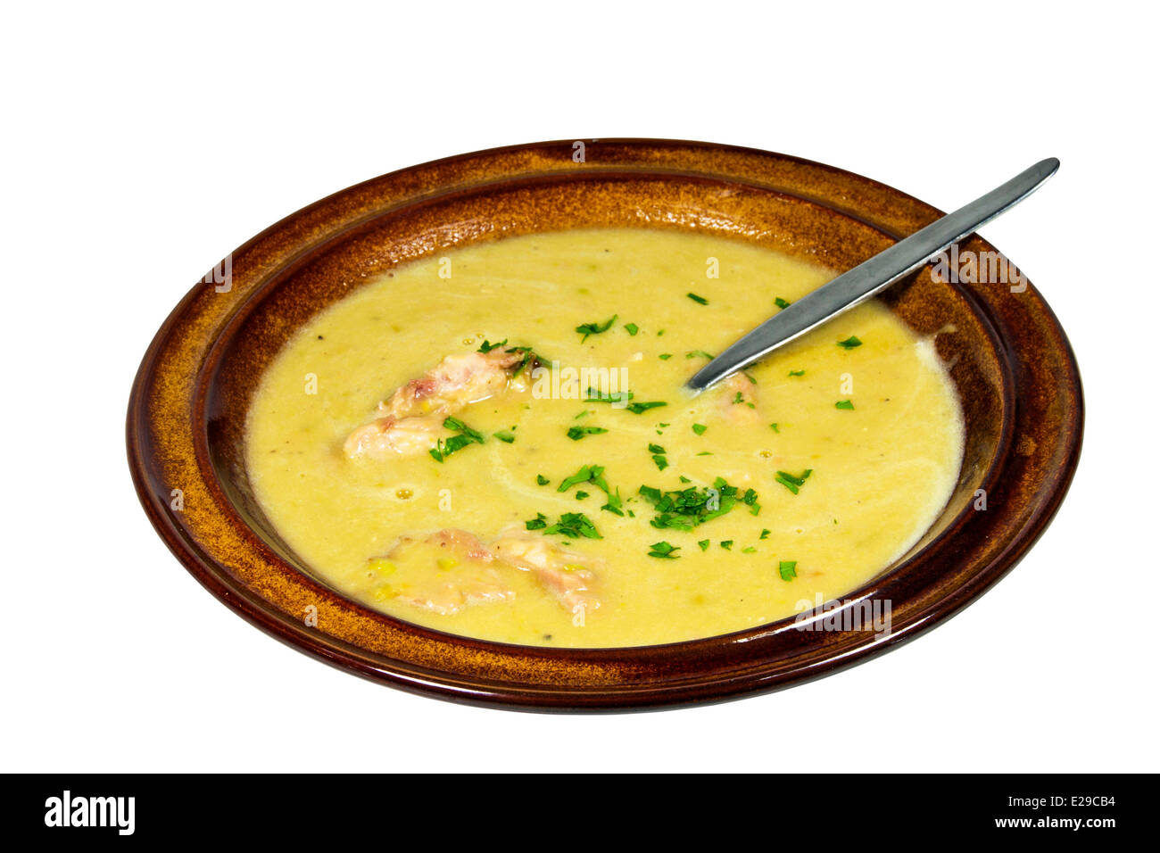 bowl of freshly cooked hearty pea and ham soup sprinkled with chopped parsley Stock Photo