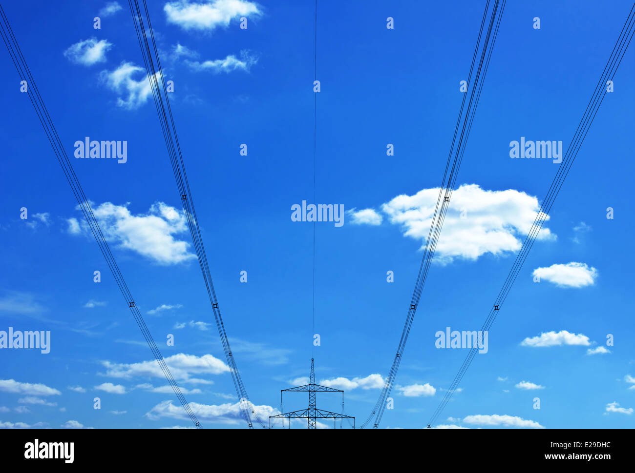 Electrical power transmission lines against blue sky Stock Photo - Alamy