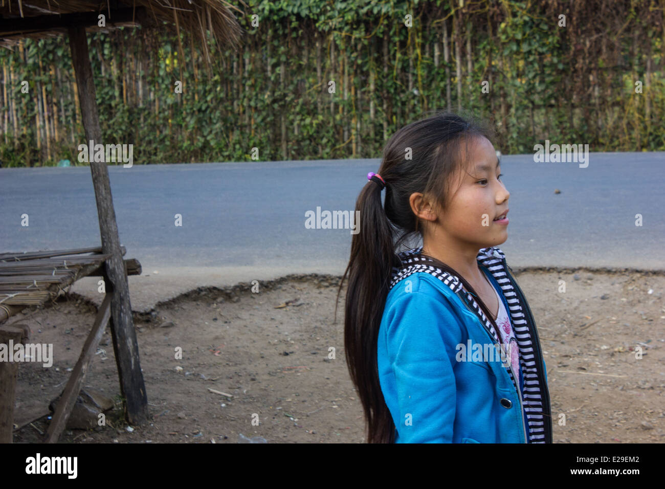 A village girl in the ancient town of Luang Prabang, situated in northern Laos, a UNESCO World Heritage Site. Stock Photo