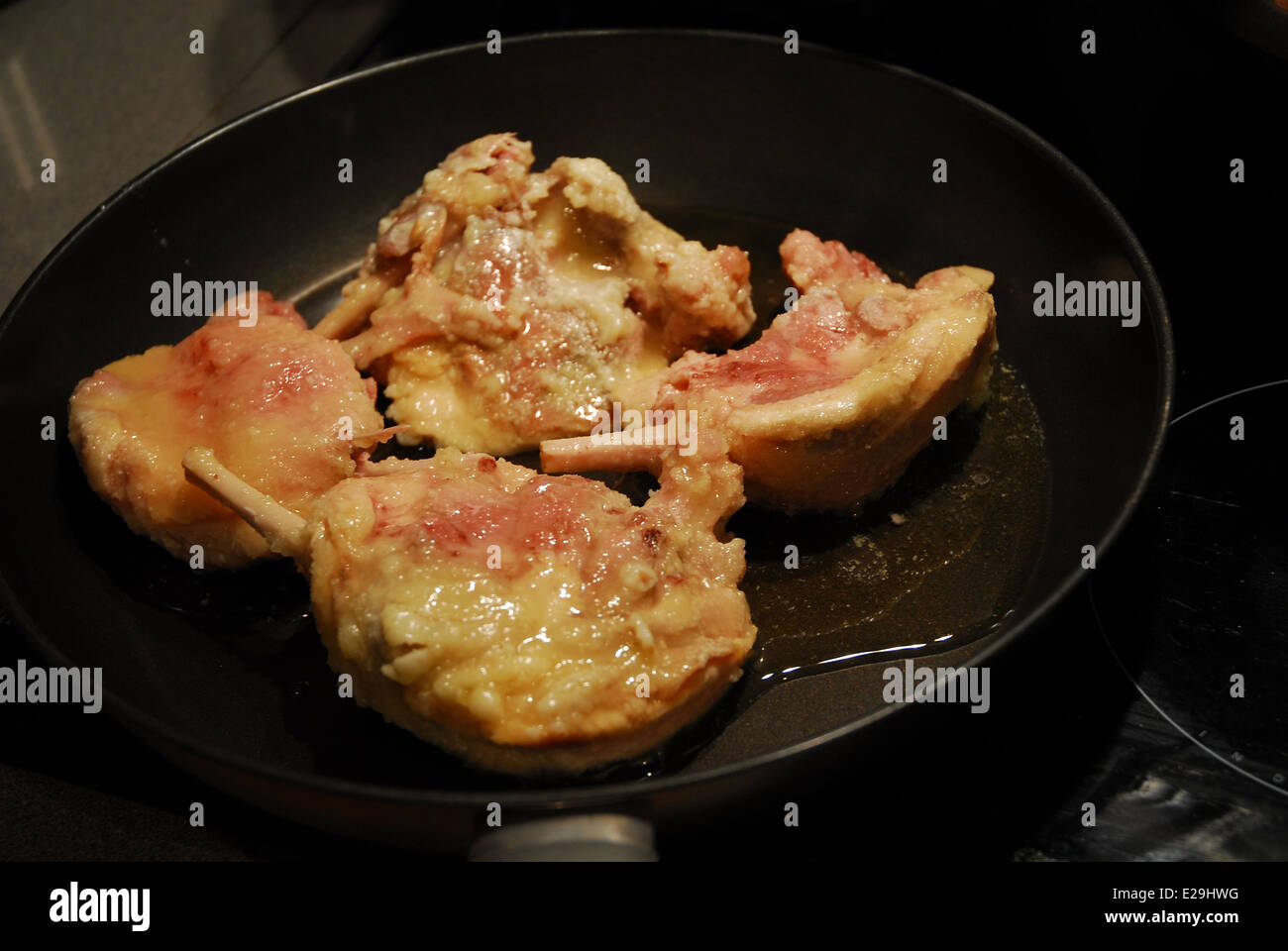 Duck confit being cooked in a frying pan Stock Photo