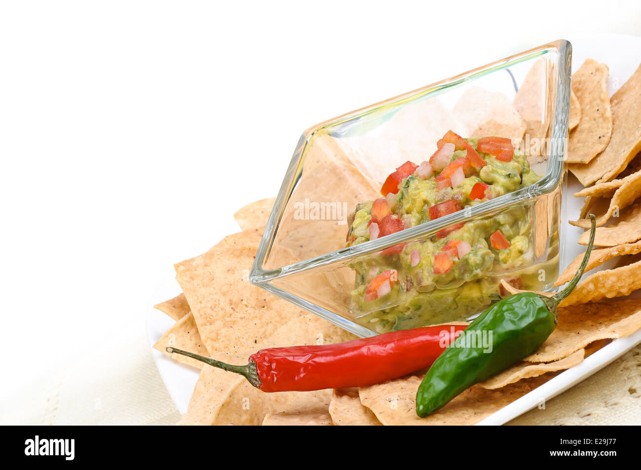 Guacamole with corn tortilla chips and chili Stock Photo Alamy