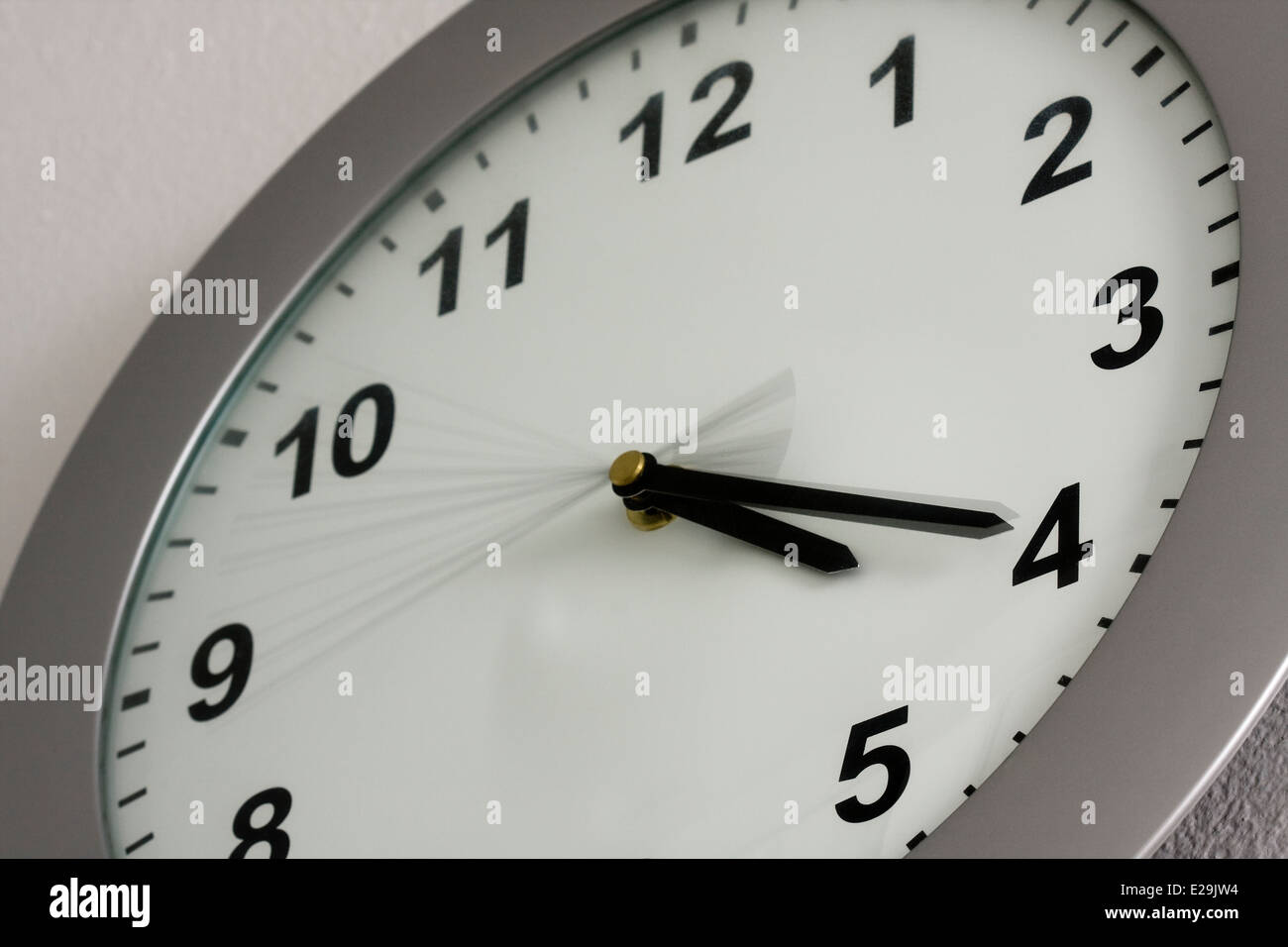 Grey Wall Clock showing the time of 4:20 Stock Photo - Alamy