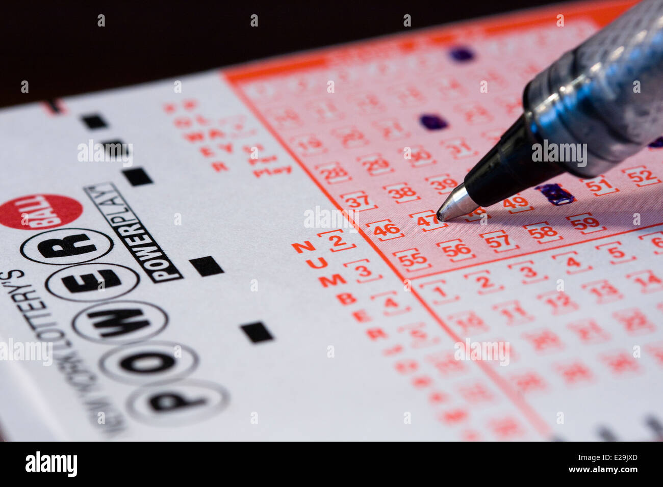 Close up of a ball point pen choosing numbers for the New York Lottery's Powerball Game Stock Photo