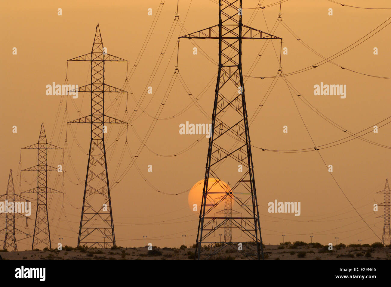 United Arab Emirates, Abu Dhabi emirate, Abu Dhabi, high voltage power lines at sunset Stock Photo