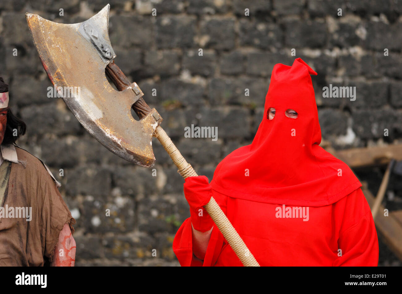 France, Ardennes, Sedan, medieval festival, executioner dressed in red holding an ax Stock Photo