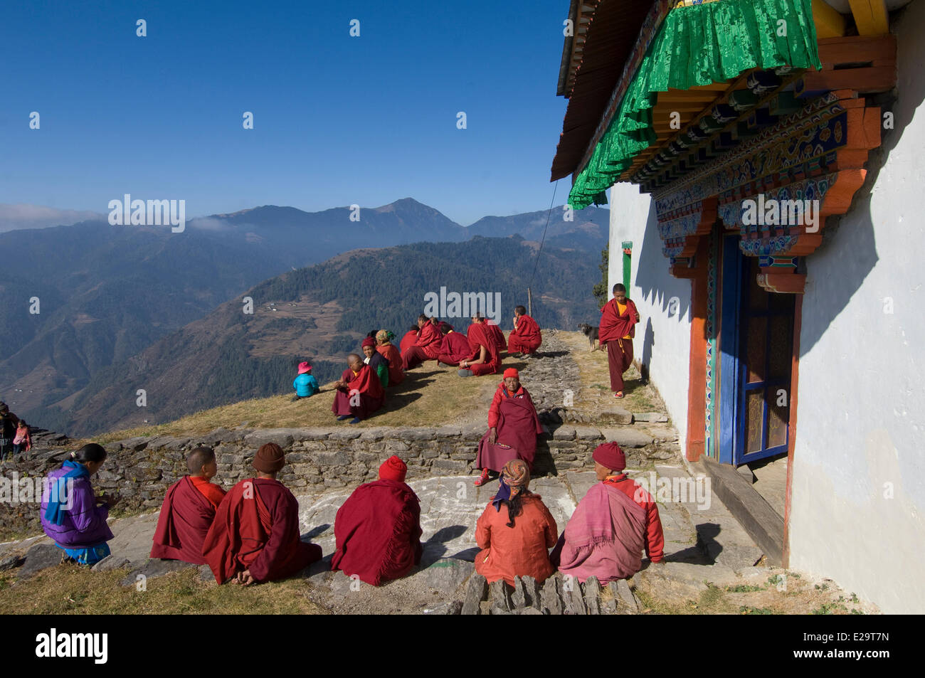 Nepal, Sagarmatha Zone, Solu Khumbu District, Chiwong Monastery, sherpa festival of Mani Rimdu, monks sunbathing at the entrance Stock Photo