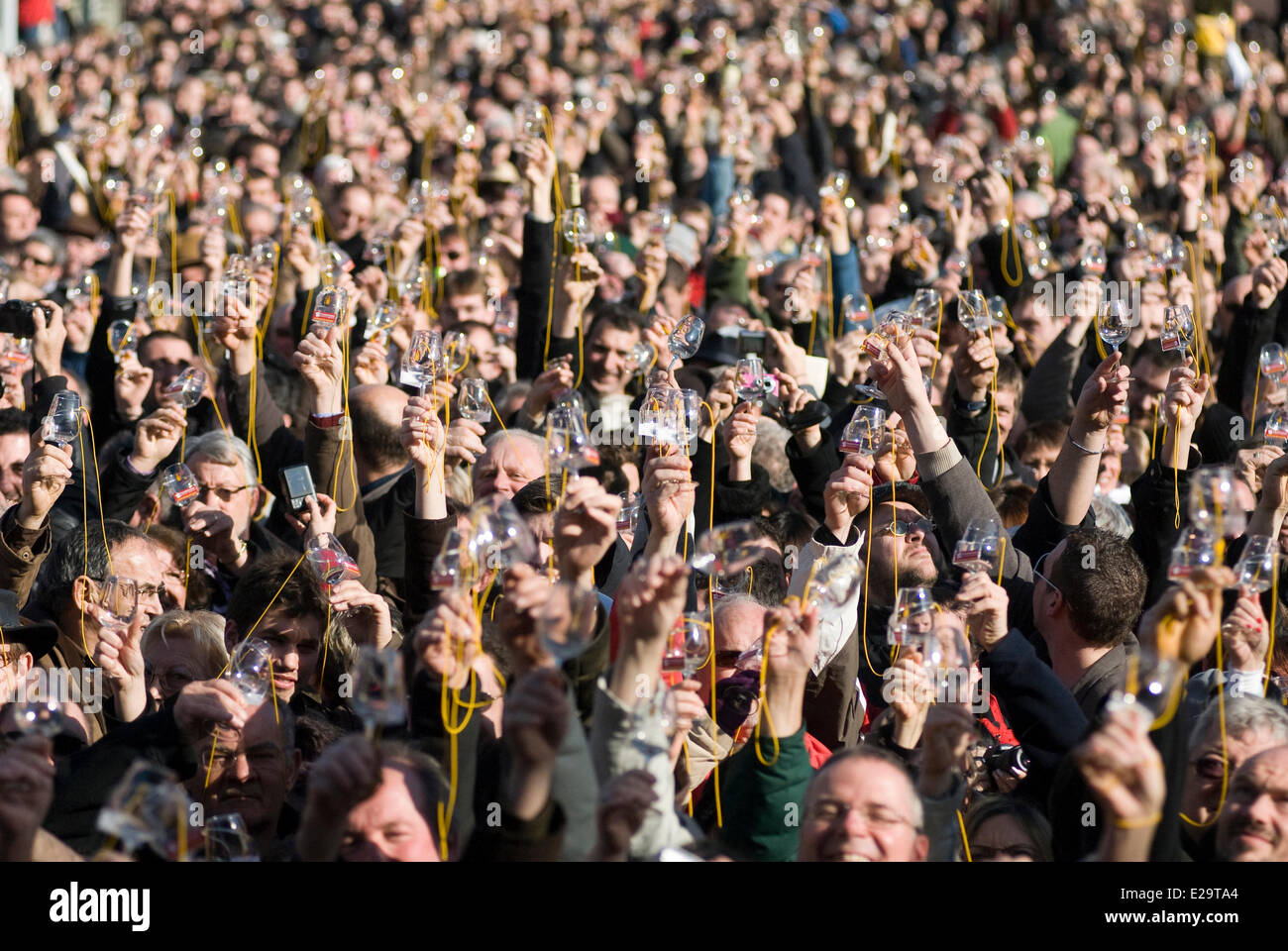 France, Jura, Arbois, breakthrough of the yellow wine, crowd raising its glass Stock Photo