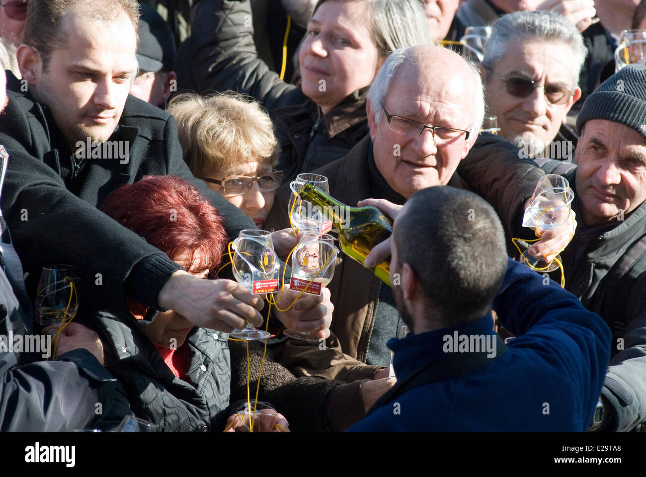 France, Jura, Arbois, breakthrough of the yellow wine, crowd raising its glass Stock Photo