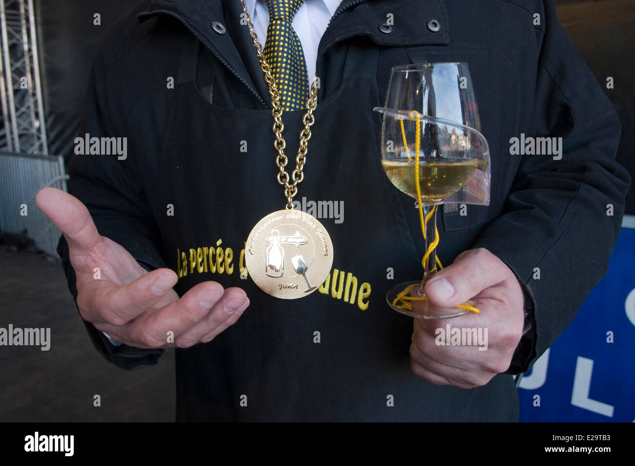 France, Jura, Arbois, breakthrough of the yellow wine, glass in the hand and the medal in the neck Stock Photo