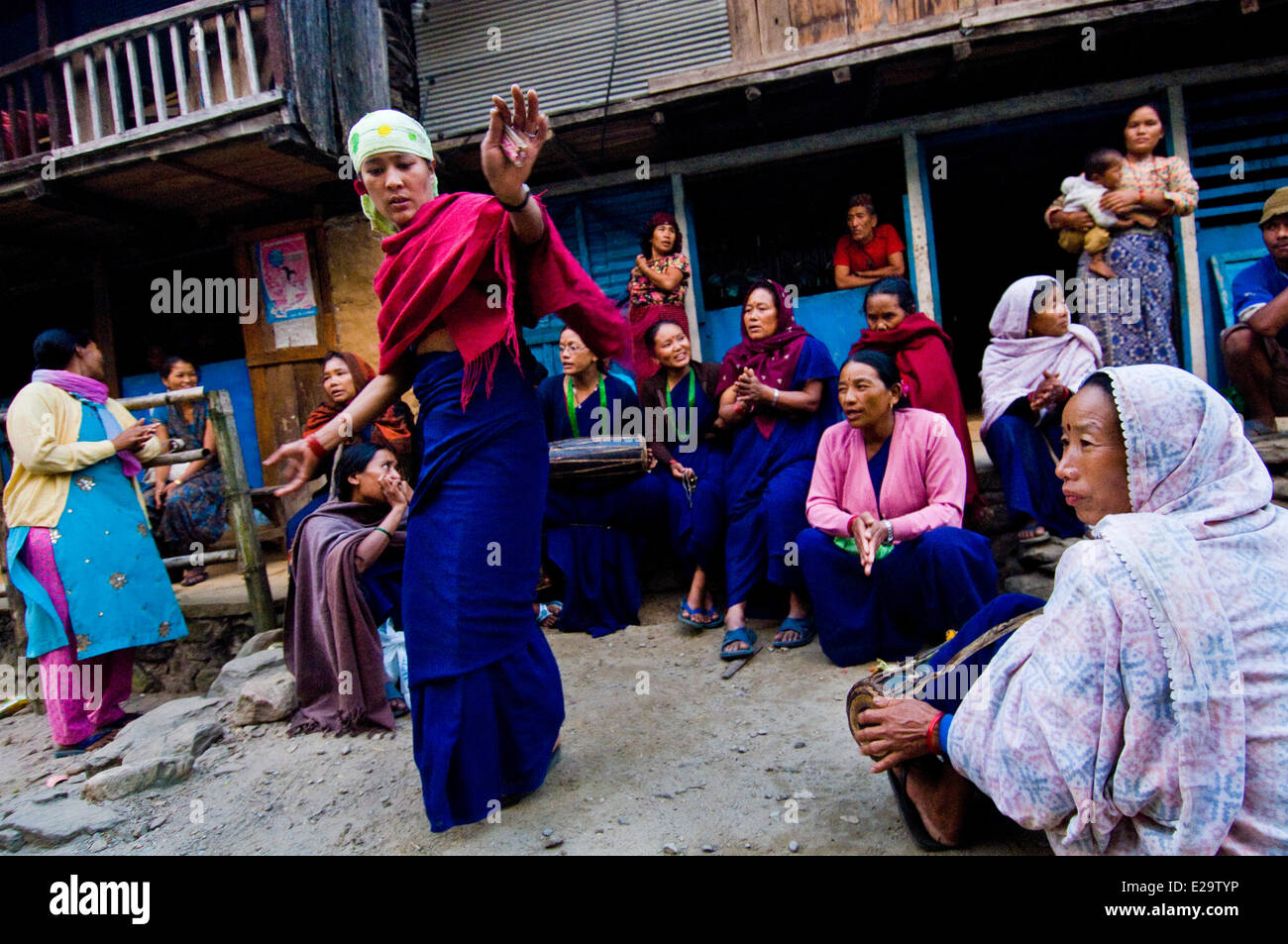 Nepal, Annapurna Trek, Gandaki Zone, Chame, villagers dance in the street to celebrate the Women's Day Stock Photo