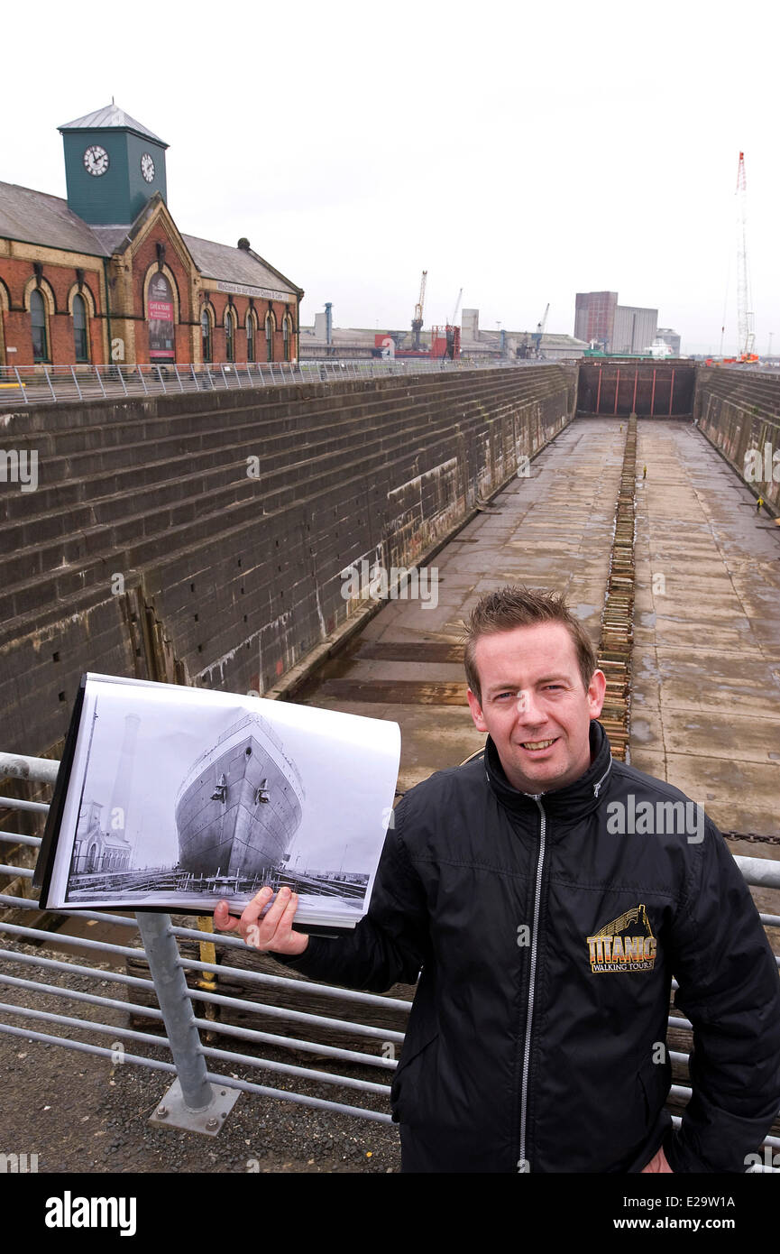 United Kingdom, Northern Ireland, Belfast, a Titanic tour guide holding a picture of the dock where Titanic was launched Stock Photo