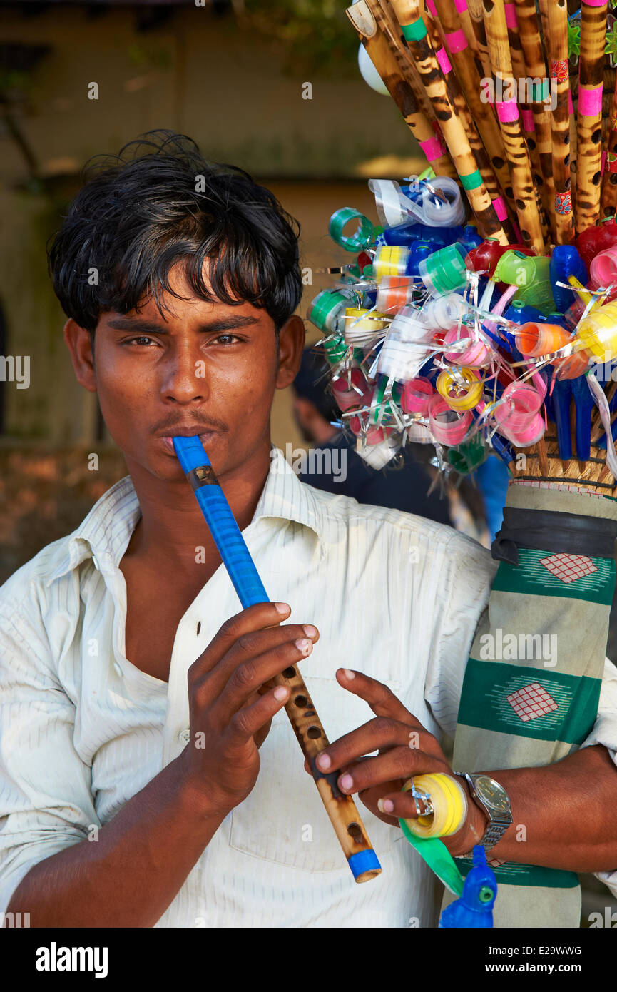 India, Kerala state, Fort Cochin or Kochi, young indian man playing on the flute Stock Photo