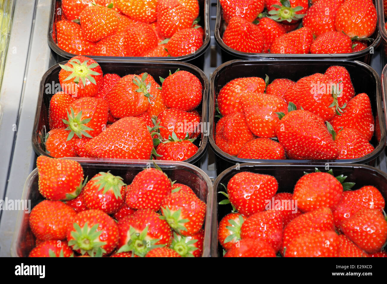 Strawberries in plastic for sale at the Saturday market