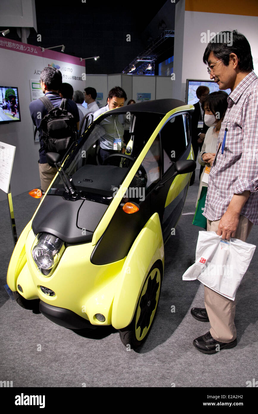 Tokyo, Japan. 18th June, 2014. – Visitors see the electric vehicle of Toyota 'i-Road' at the Smart Community Japan 2014 in Tokyo Big Sight on June 18, 2014. The exhibition brings the latests products and technologies divided in 5 categories, 'Smart Community Exhibition', 'Biomass Expo', 'Next Generation Vehicle Exhibition, and newly-created 'Community Cloud 2014', which introduces technology for urban development. This year 229 enterprises and organizations shows their products from June 18th to 20th. Credit:  Aflo Co. Ltd./Alamy Live News Stock Photo