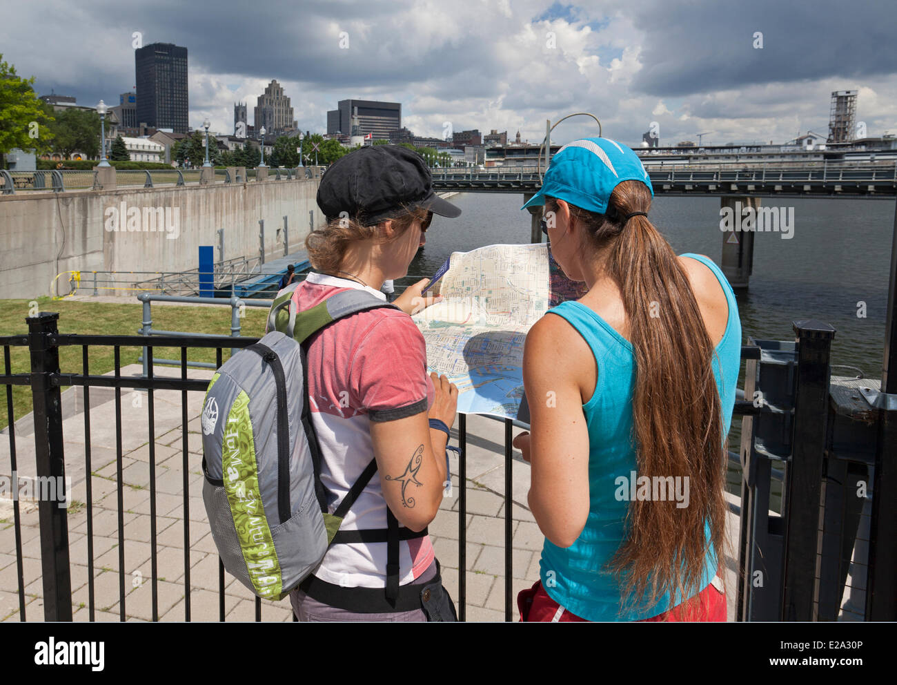 Canada, Quebec Province, Montreal, Old Montreal, Old Port, young tourists looking at a city map Stock Photo