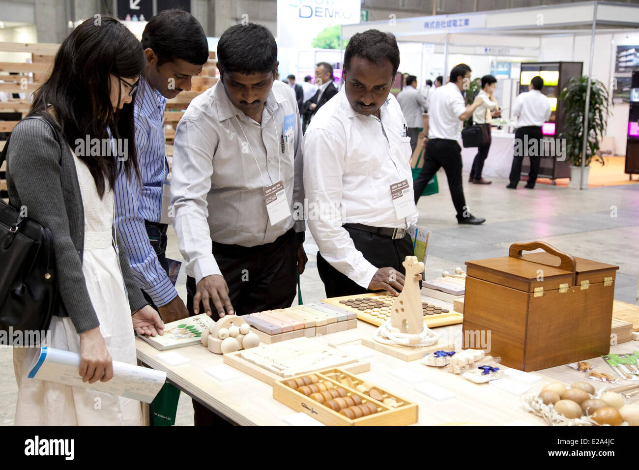 Tokyo, Japan. 18th June, 2014. – Visitors see different products made by wood at the Smart Community Japan 2014 in Tokyo Big Sight on June 18, 2014. The exhibition brings the latests products and technologies divided in 5 categories, 'Smart Community Exhibition', 'Biomass Expo', 'Next Generation Vehicle Exhibition, and newly-created 'Community Cloud 2014', which introduces technology for urban development. This year 229 enterprises and organizations shows their products from June 18th to 20th. Credit:  Aflo Co. Ltd./Alamy Live News Stock Photo
