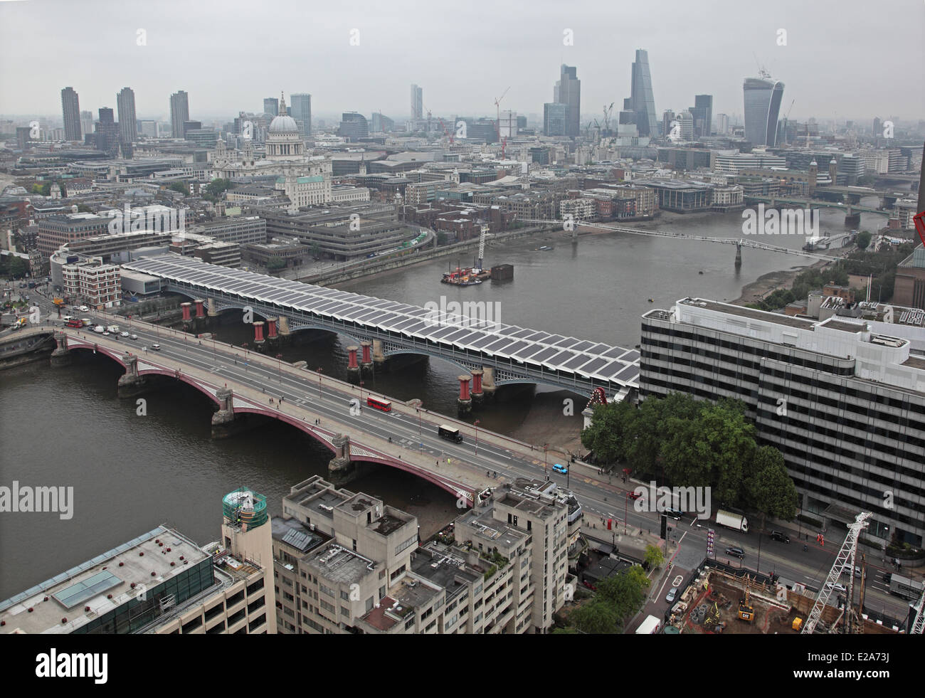 A view of the River Thames from high level showing Blackfriars Road and rail bridges with the City of London skyline Stock Photo