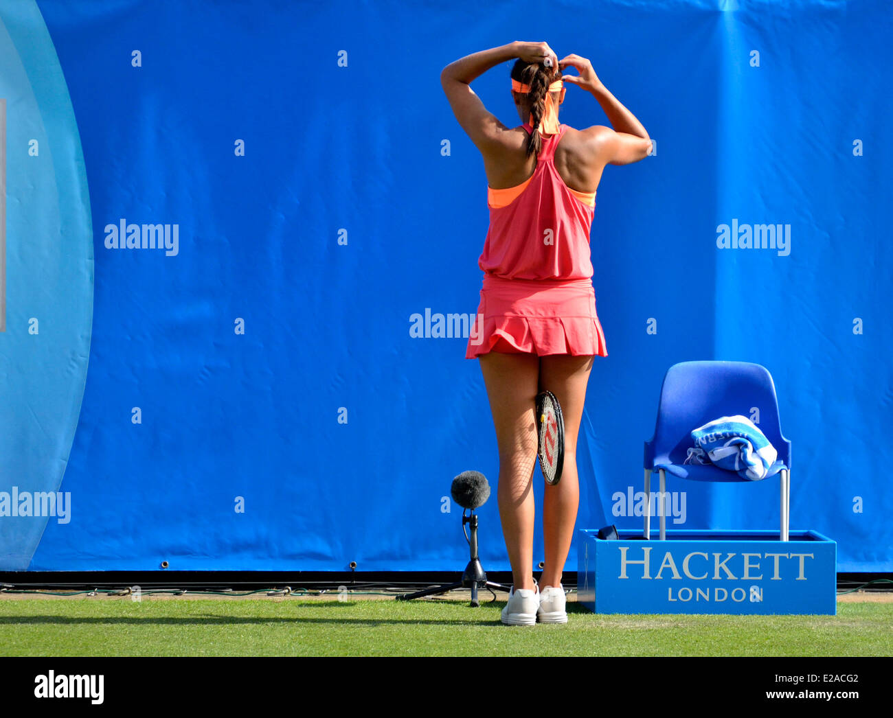 Madison Keys (USA) tying her hair during a match at Devonshire Park, Eastbourne, 2014 Stock Photo