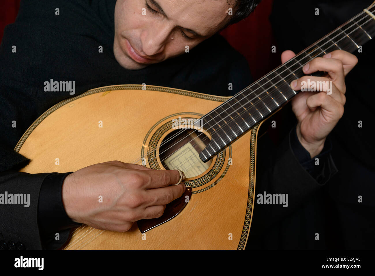 Close up of person playing portuguese guitar during a Fado performance Stock Photo
