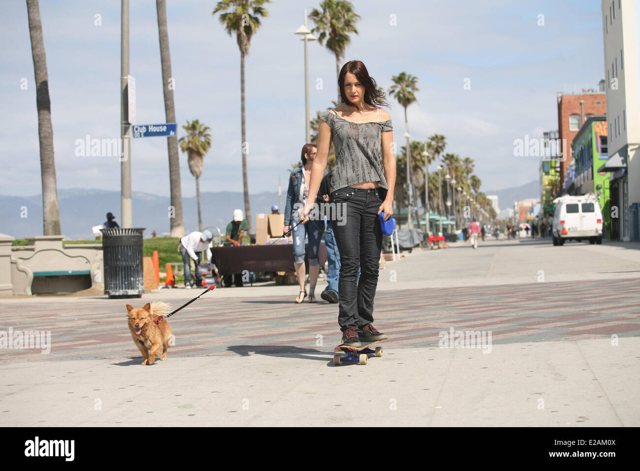 United States, California, Los Angeles, Venice Beach, girl skateboarding with dog Stock Photo