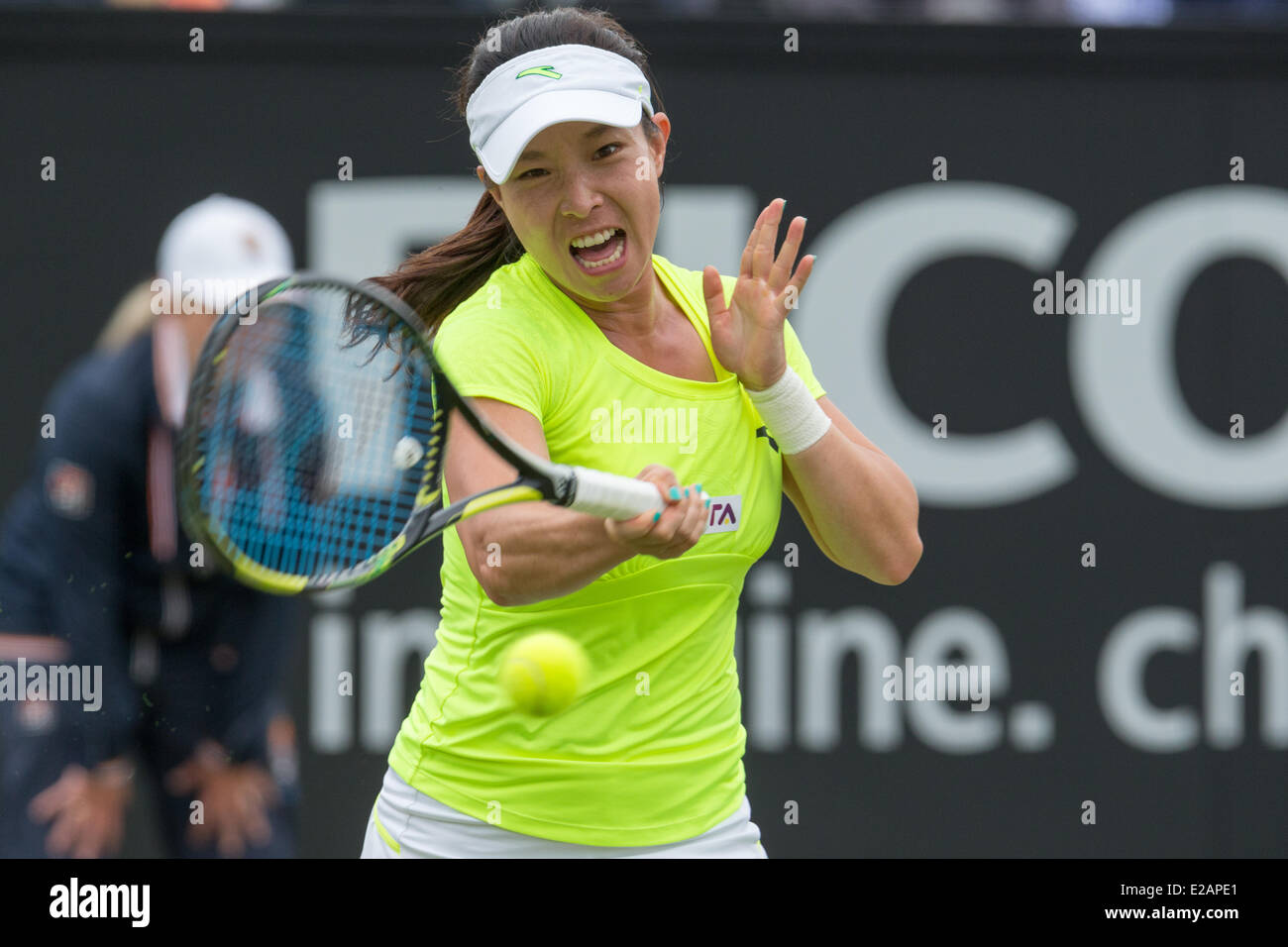 Rosmalen, The Netherlands. 18th June, 2014. Chinese tennis player Jie Zheng hits a forehand during the 2nd round singles match of the Topshelf Open 2014 at Autotron, Rosmalen, Netherlands on 18.06.2014. She won against Carla Suarez Navarro (ESP) who had to retire at 7:5 0:1 due to back problems.  Credit:  Janine Lang/Alamy Live News Stock Photo