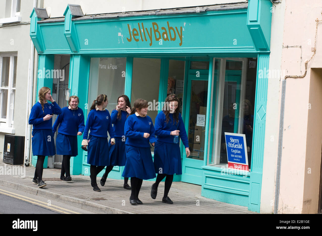 Ireland, County Kerry, Killarney, schoolgirls in uniform on the street Stock Photo