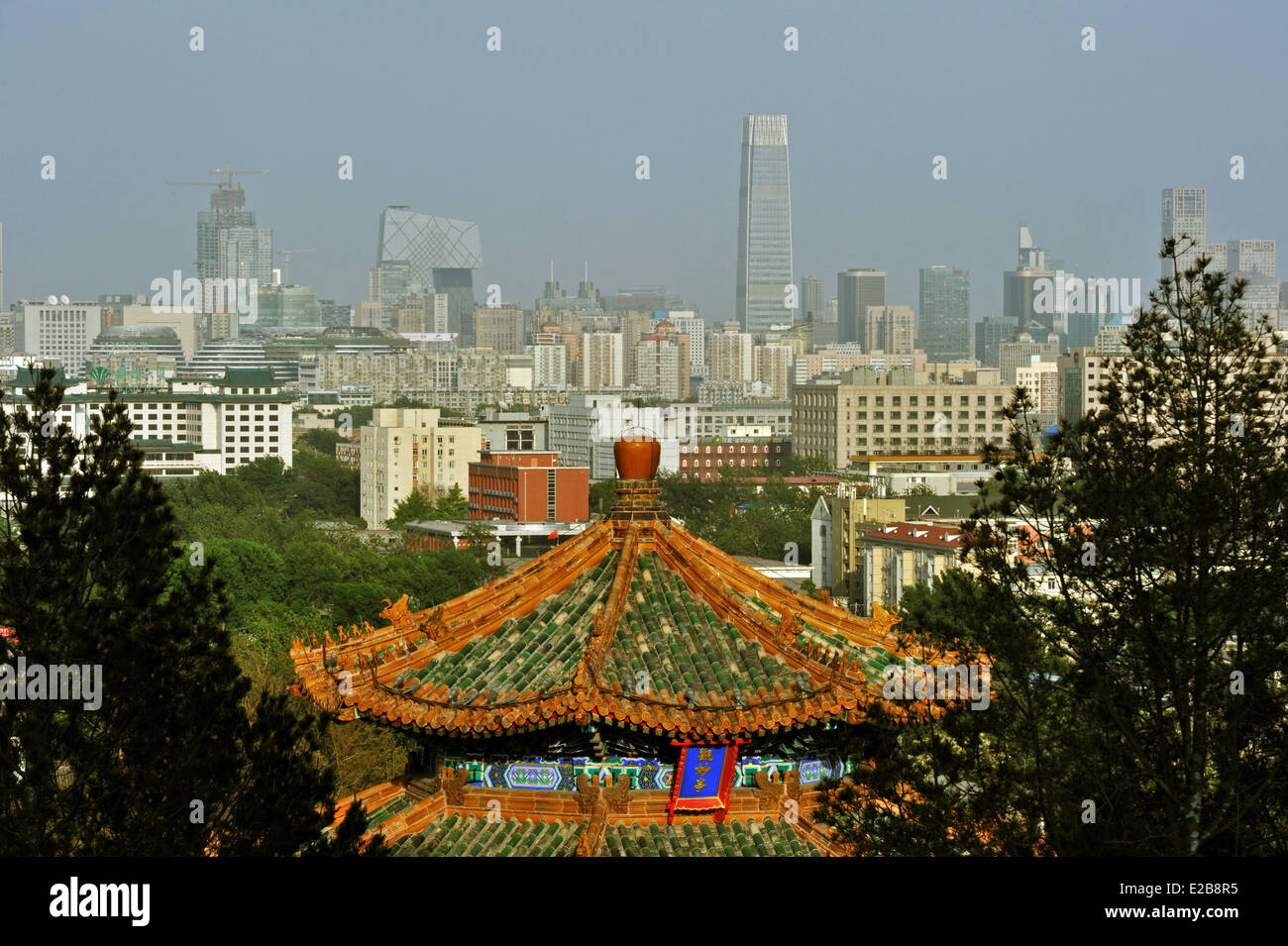 China, Beijing, Temple in the Park of the Coal Hill (Jingshan Park) with CCTV and China World Tower in the back Stock Photo