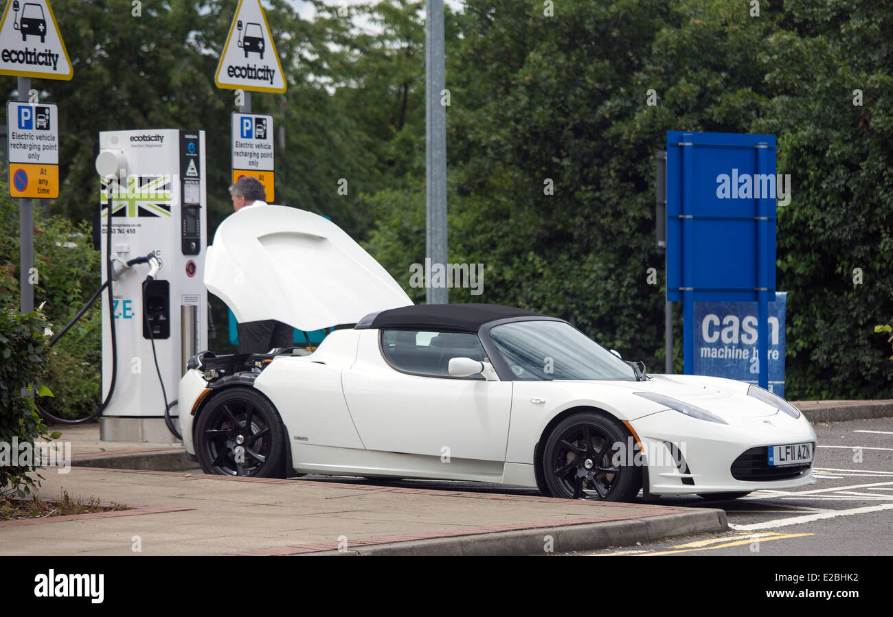 Roadster electric car on charge at Services. battery electric vehicle (BEV) sports car can do 0-60 i Stock Photo - Alamy