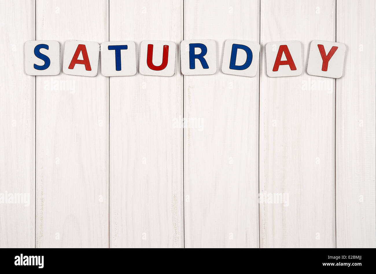 Inscription on Saturday against a white wood texture Stock Photo - Alamy