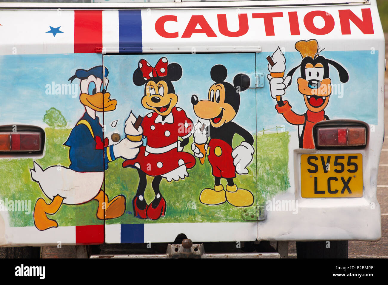 caution with artwork with Micky Mouse, Minnie Mouse, Goofy and Donald Duck on back of ice cream van - close up detail Stock Photo