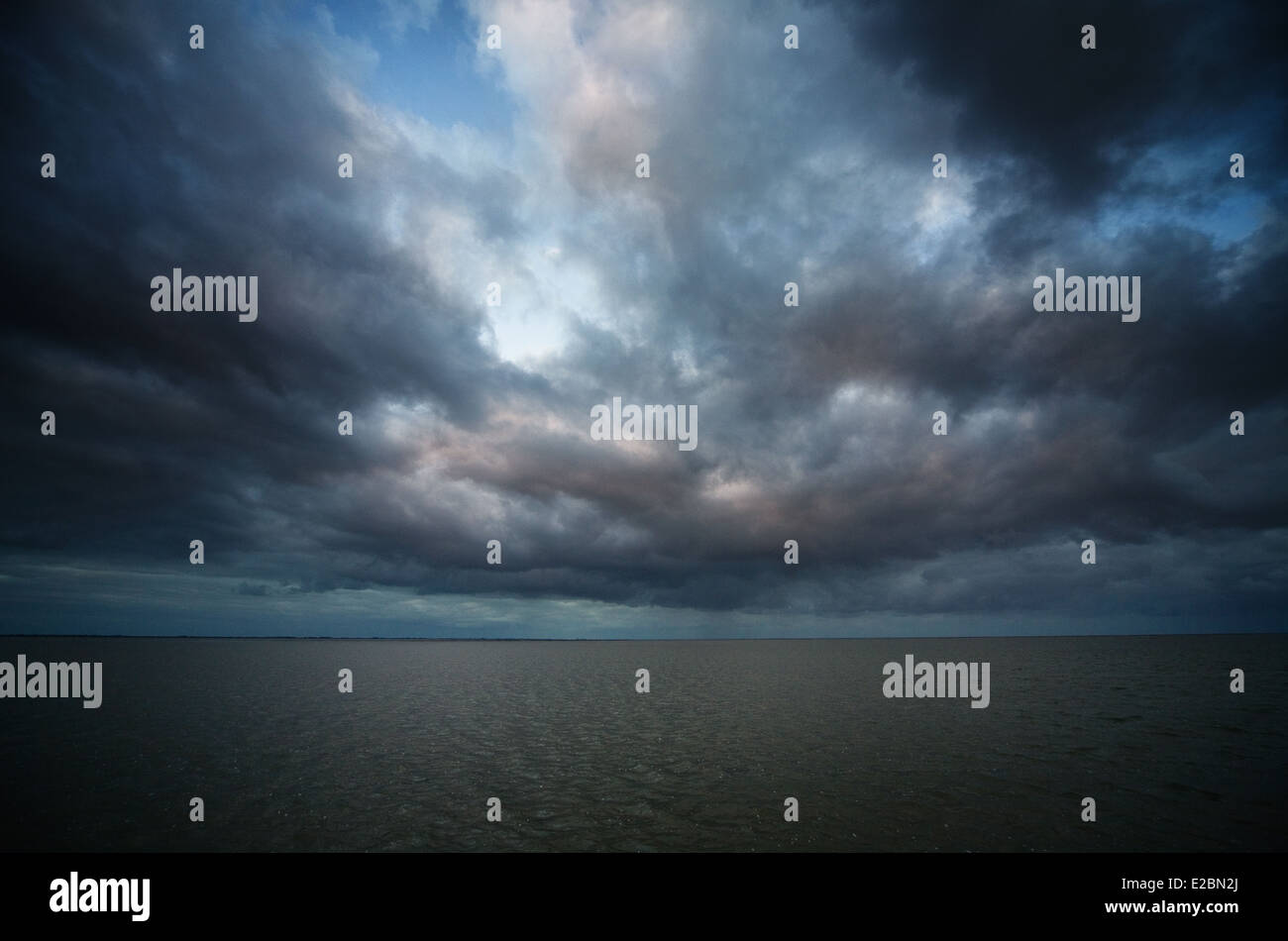 Dark clouds above the waddenzee during a night walk called wadlopen Stock Photo