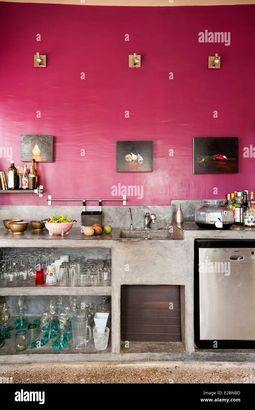Pink kitchen with polished cement workbench in Baja home Stock Photo