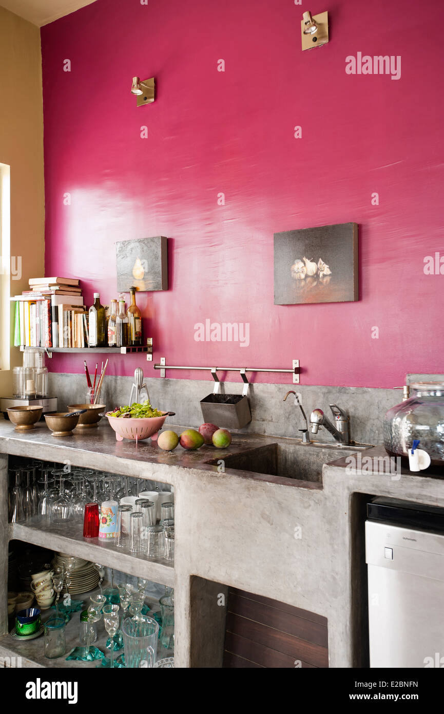 Pink kitchen with polished cement workbench in Baja home of English interior designer Jenny Armit Stock Photo