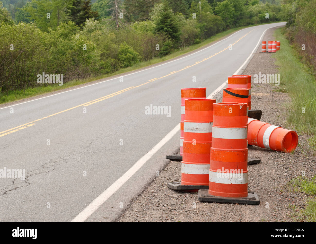 Traffic cones beside rural highway. Stock Photo