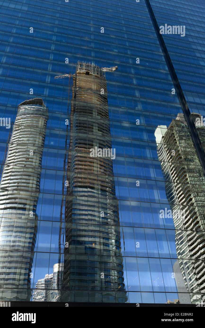 Reflections of new condominium development in blue glass of PwC tower office building Toronto Stock Photo