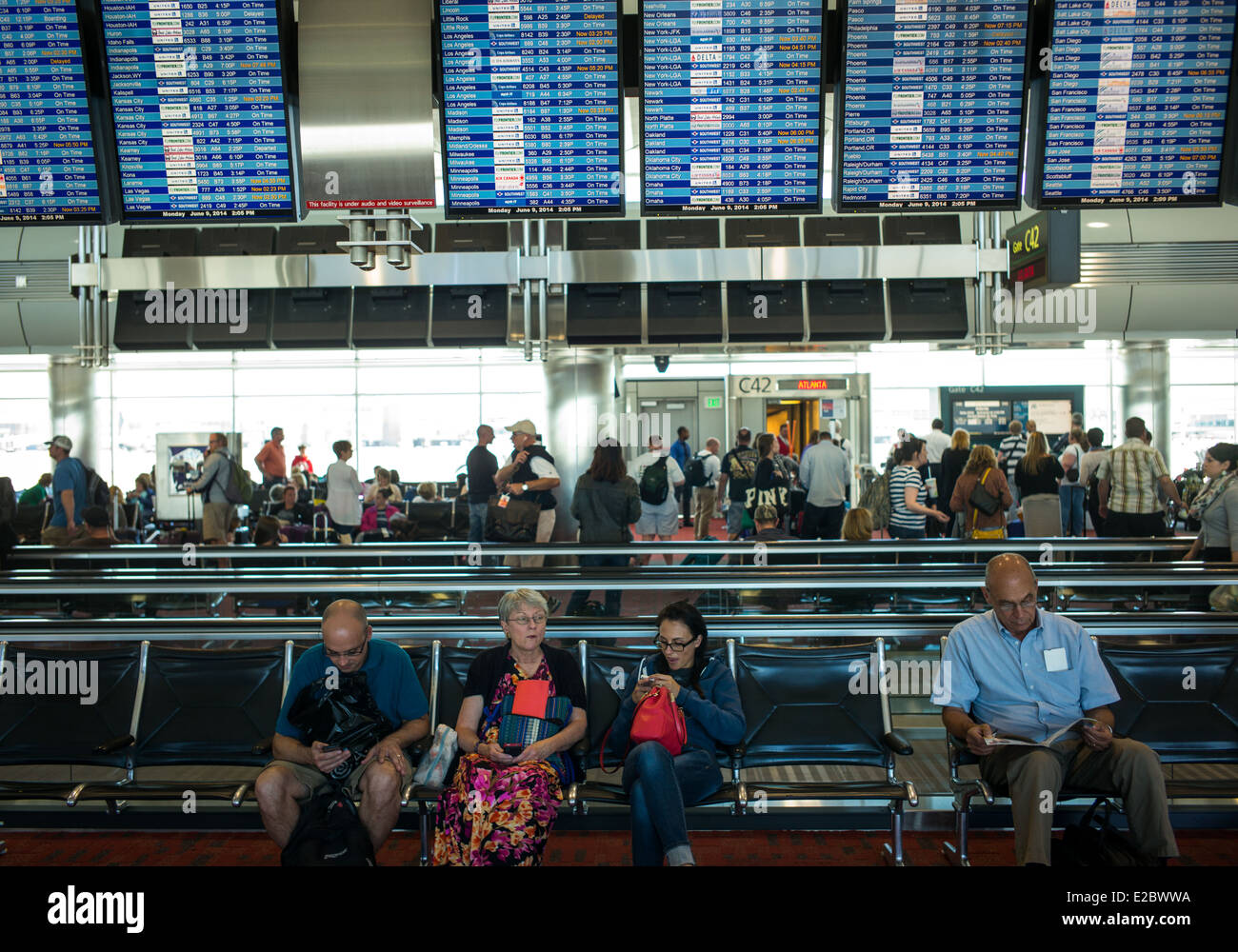 Passengers wait for their departing flights at the Stapleton International Airport in Denver, Colorado. Stock Photo