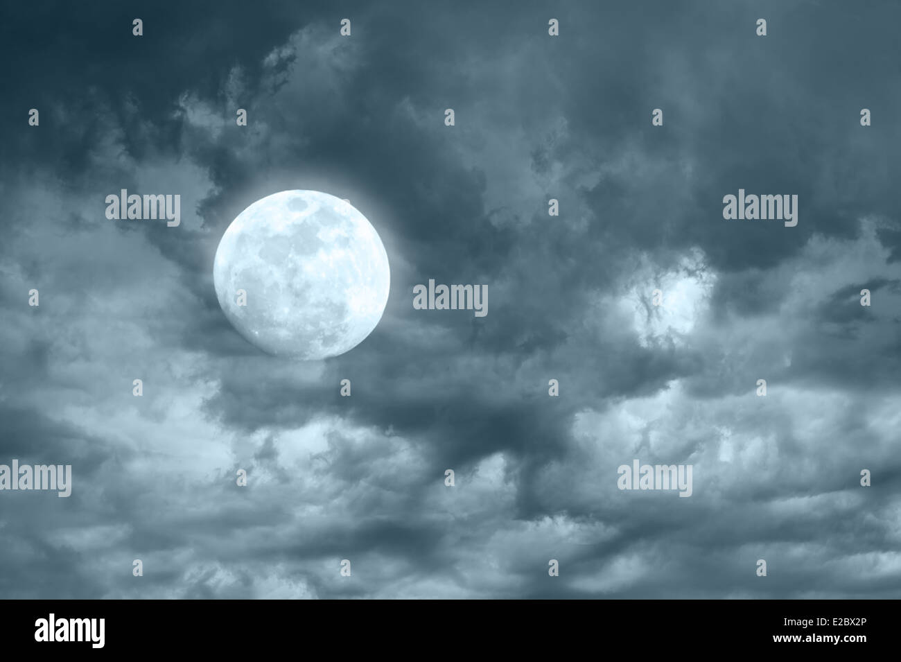 Amazing night sky with shining full moon and dramatic clouds Stock Photo