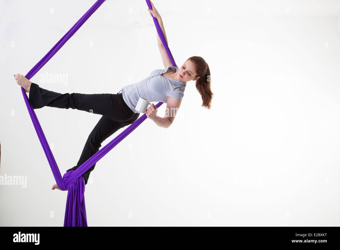 Work-life balance Woman suspended from the ceiling with a coffee mug ...