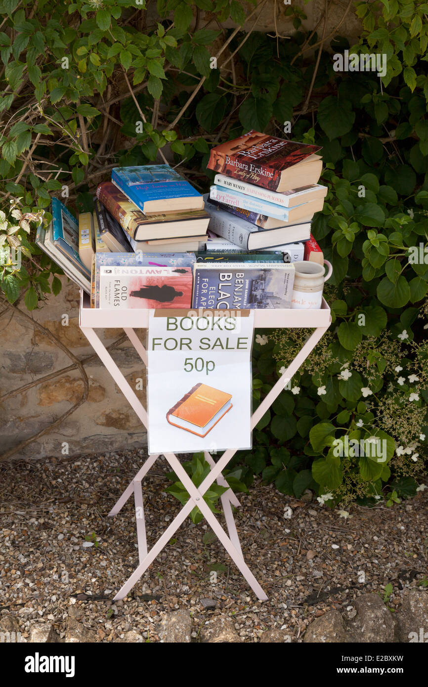 A Small Table With Second Hand Books For Sale Outside A House In The 