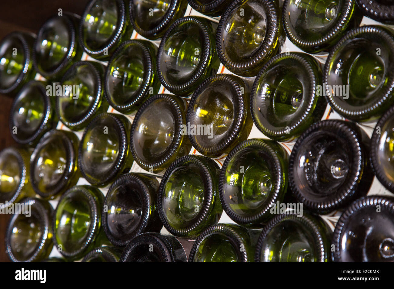Bottoms of wine bottles on a shelf of wine cellar Stock Photo