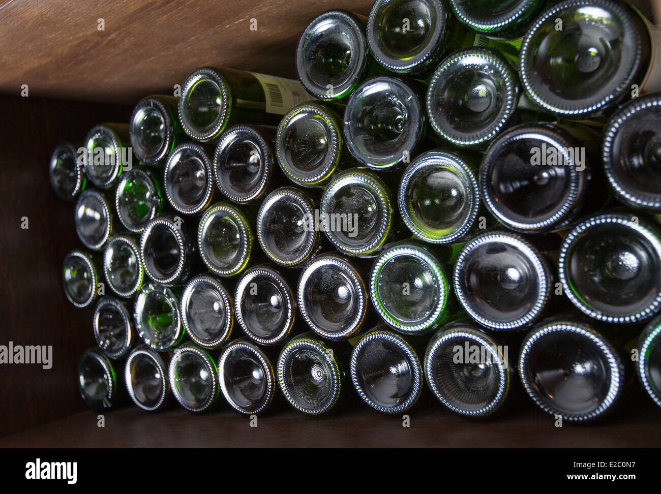 Bottoms of wine bottles on a shelf of wine cellar Stock Photo Alamy