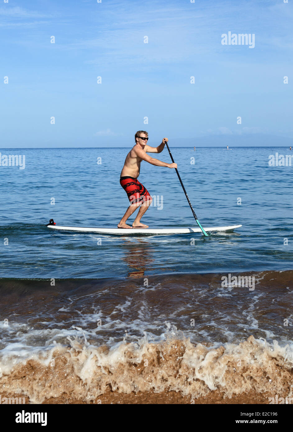Man stand up paddle surfing at Wailea Beach on Maui Stock Photo