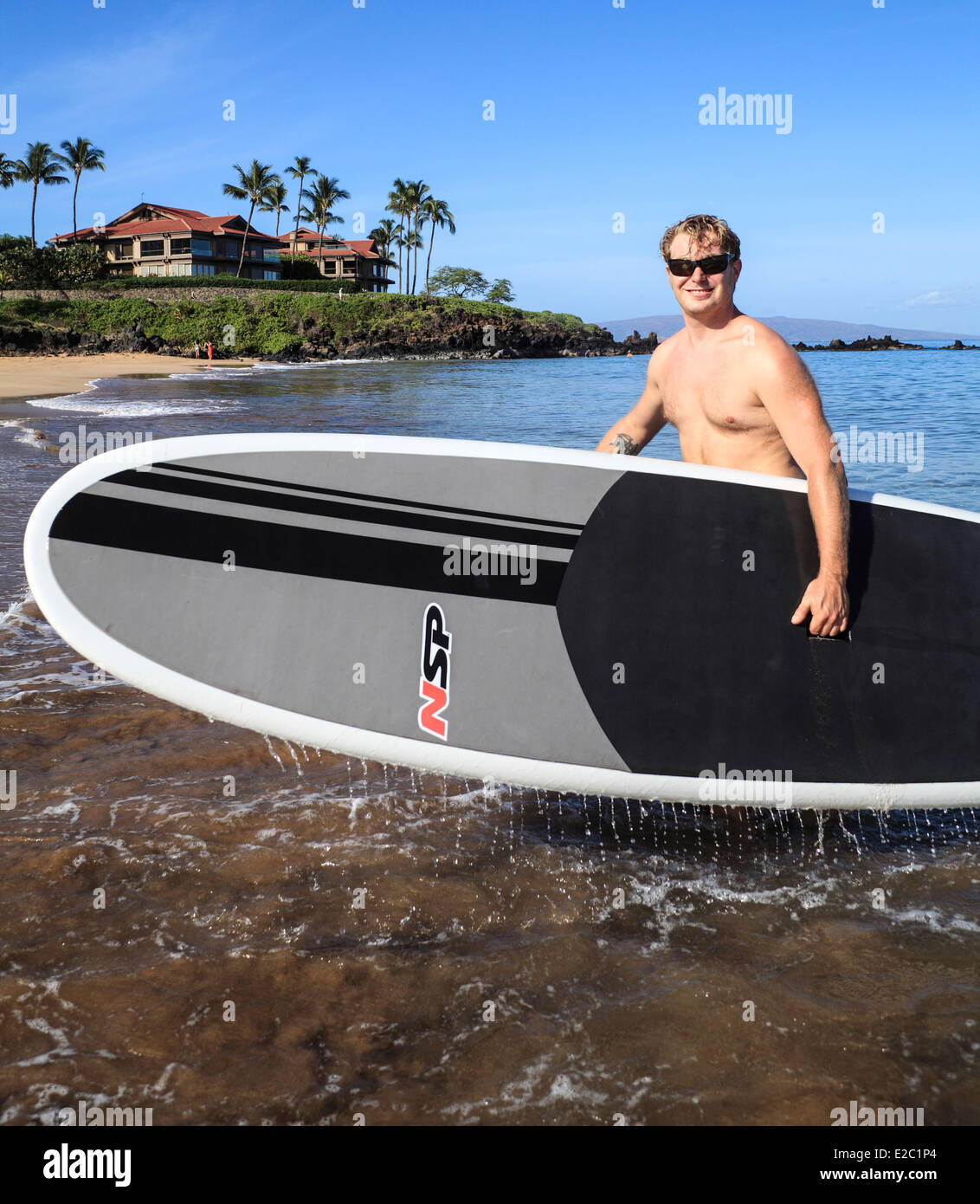 Man with stand up paddle board at Wailea Beach on Maui Stock Photo