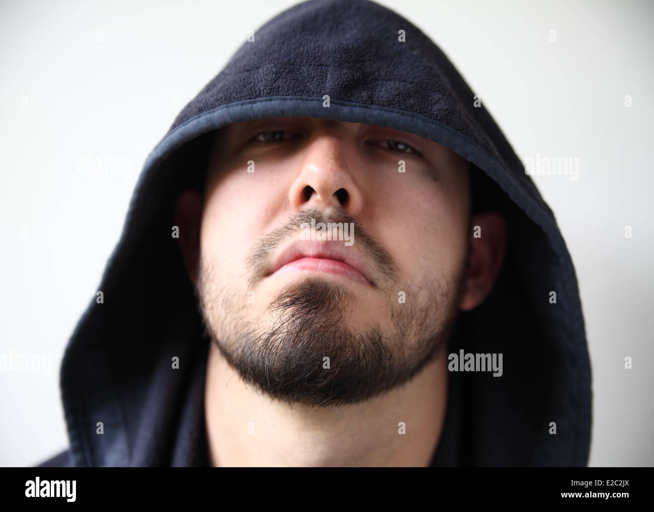 young man with dark hood hiding part of his face Stock Photo