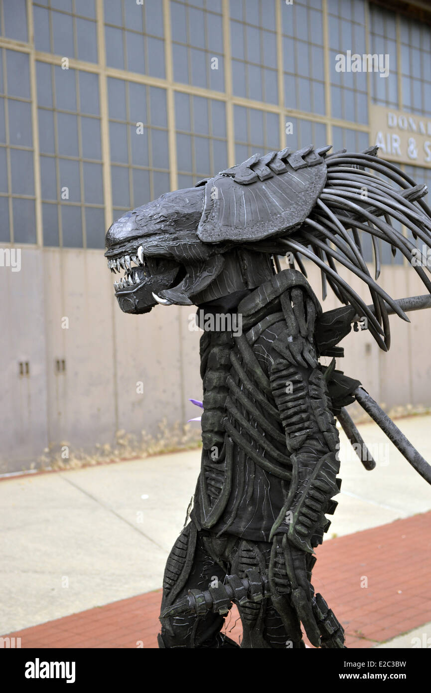Garden City, New York, USA. 14th June, 2014. A man in an Alien costume, based on Alien VS Predator movie, walks in front of an historic Mitchel Field hangar at Eternal Con, the Long Island Comic Con Pop Culture Expo, held at the Cradle of Aviation Museum. © Ann Parry/ZUMA Wire/ZUMAPRESS.com/Alamy Live News Stock Photo