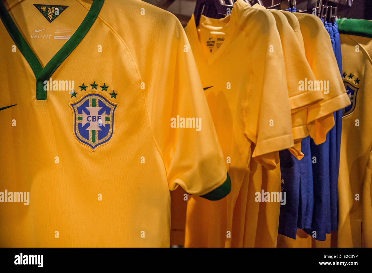 New York, NY, US. 18th June, 2014. At the Nike flagship store in midtown Manhattan the World Cup in Brazil is good for buisiness. Soccer tops and anything to do with the World Cup in Brazil are flying off of the shelves. America has arrived on the biggest soccer stage and there is World Cup fever. A Brazil or U,S. top costs around $100.00 and many people people now support more than one team. Soccer is big buisiness and companys like Nike support everyone. Stock Photo
