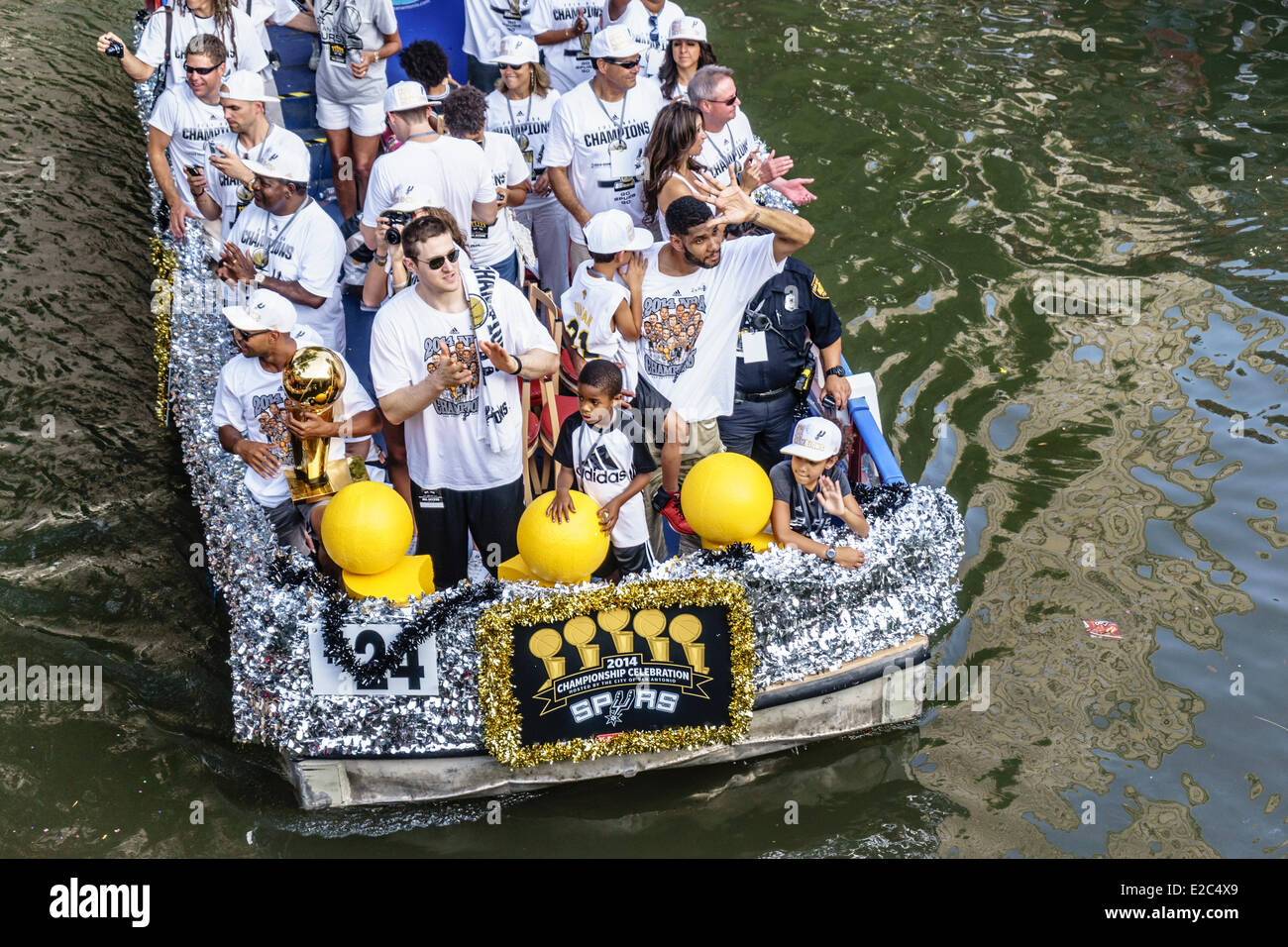 San Antonio, Texas, US. 18th June, 2014. San Antonio Spurs celebrate winning the 2014 NBA Finals on The Riverwalk in downtown San Antonio Texas on June 18 2014. Patty Mills, Aron Baynes, and Tim Duncan waving to the crowd holding the NBA Championship Trophy. Credit:  Jon-Paul Jones/Alamy Live News Stock Photo