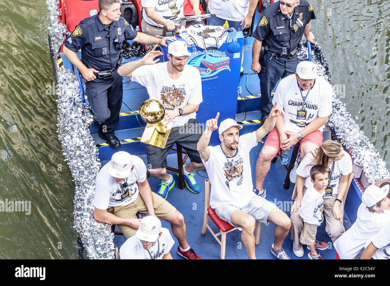 San Antonio, Texas, US. 18th June, 2014. San Antonio Spurs celebrate winning the 2014 NBA Finals on The Riverwalk in downtown San Antonio Texas on June 18 2014. Manu Ginobili and Tiago Splitter holding the 2003 NBA Championship trophy and waving to the crowd. Credit:  Jon-Paul Jones/Alamy Live News Stock Photo