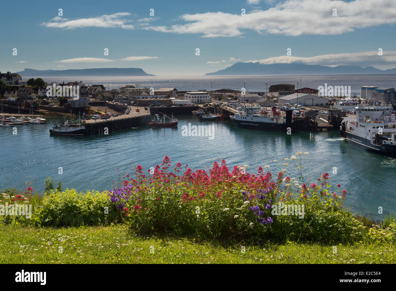 Mallaig harbour and the Western Isles of Rhum and Eigg in mid-summer sunshine. Stock Photo