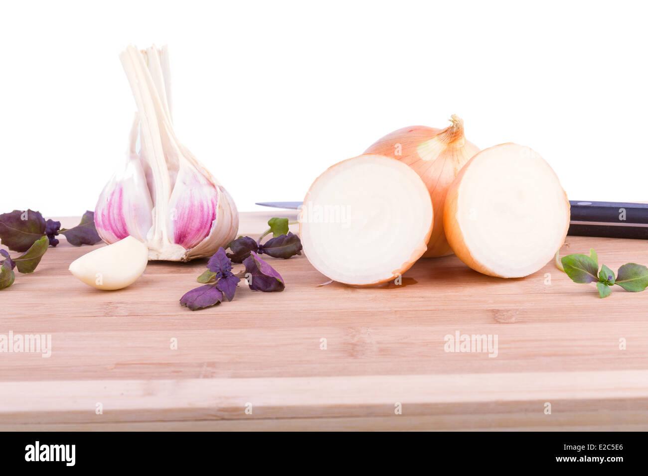 Onions, garlic and basil on chopping board Stock Photo Alamy